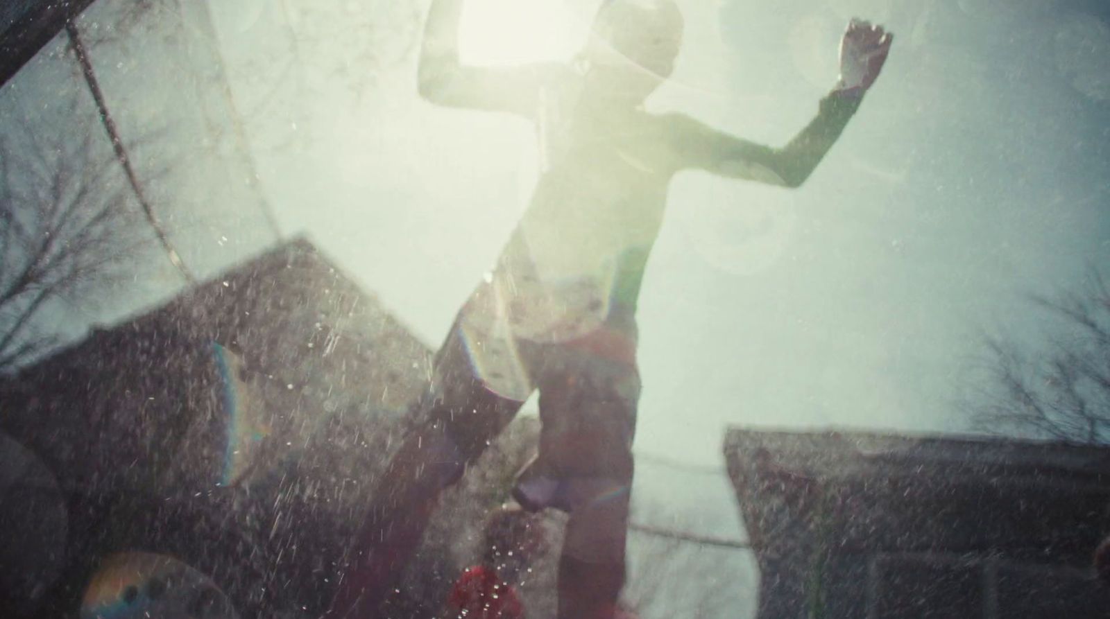 a man standing in the rain with his arms outstretched