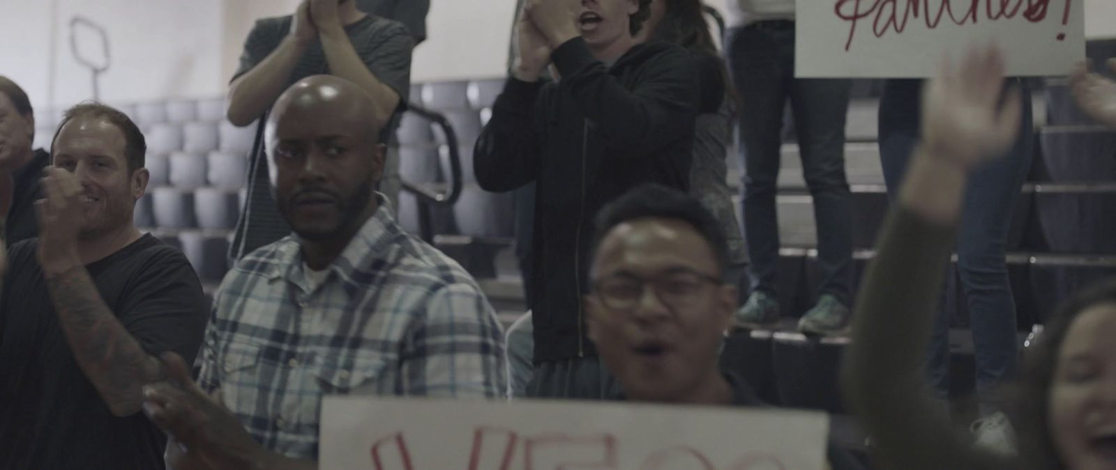 a group of people holding up signs in a room