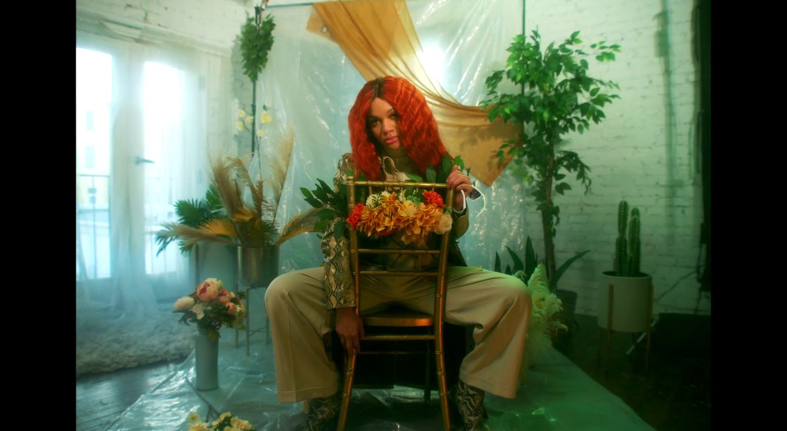 a woman with red hair sitting on a chair