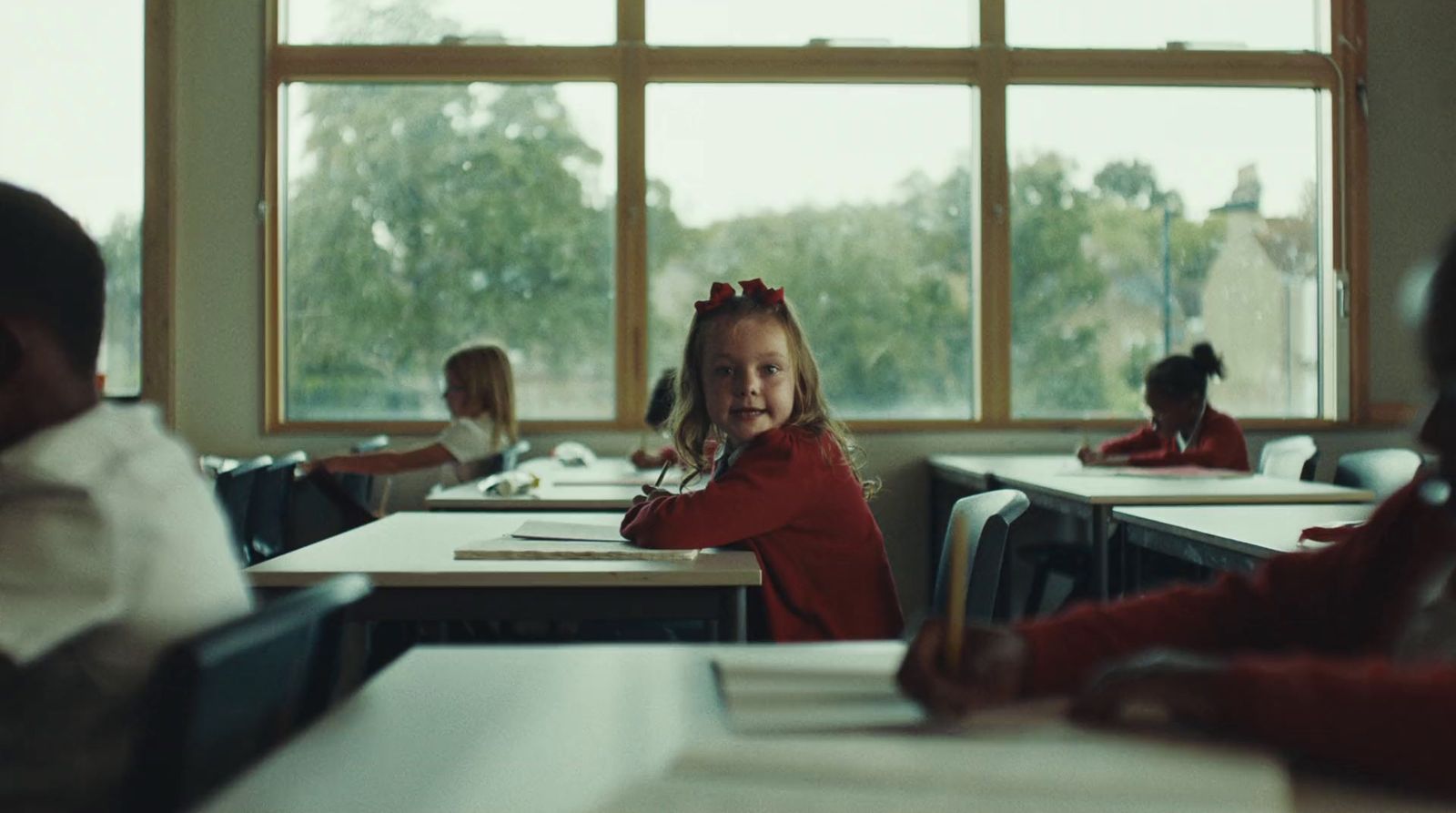 a group of children sitting at desks in a classroom