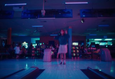 a couple of people that are standing in a bowling alley