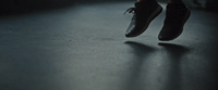 a person's feet on a skateboard in the dark