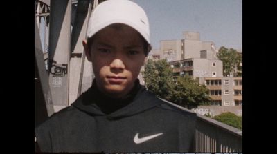 a young man wearing a white hat and a black shirt