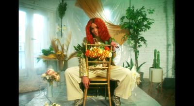 a woman with red hair sitting on a chair