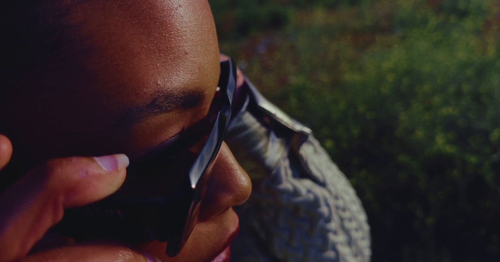 a close up of a person talking on a cell phone