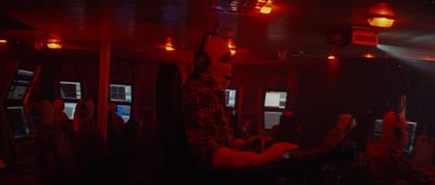 a group of people sitting in a room with red lights