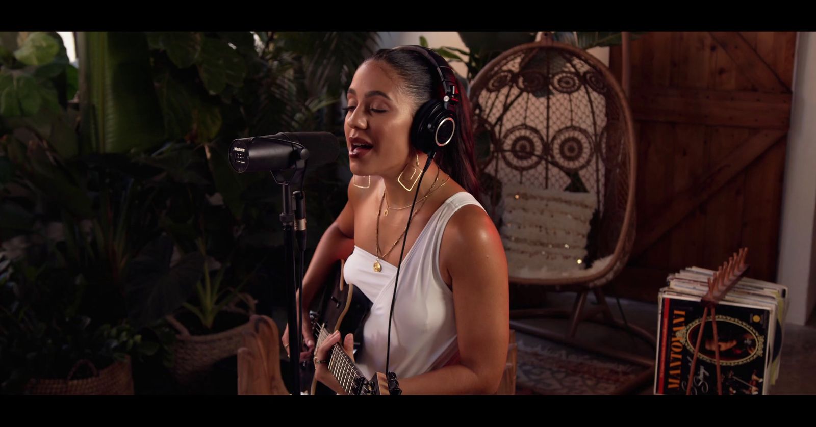 a woman wearing headphones singing into a microphone