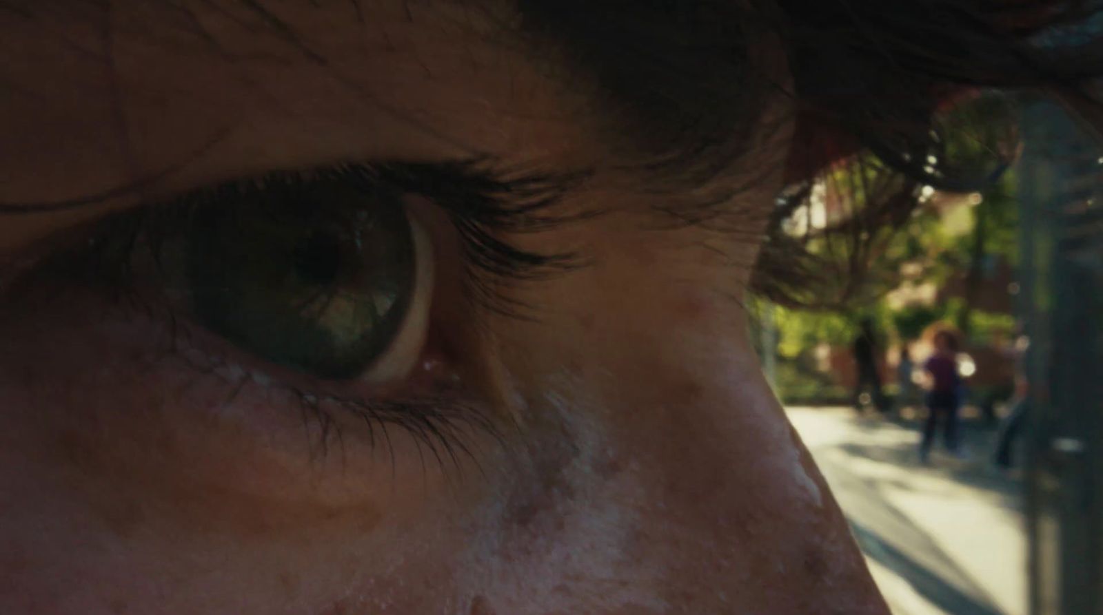 a close up of a person's eye on a city street