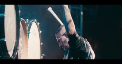 a man is playing drums on a stage