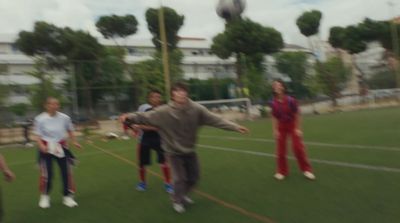 a group of young people playing a game of frisbee