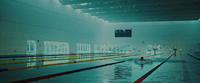 a man swimming in a large swimming pool