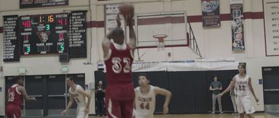 a group of young men playing a game of basketball