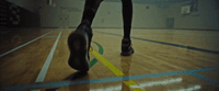 a person is walking on a basketball court