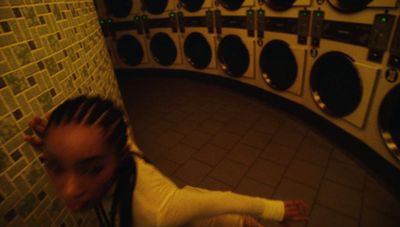 a woman standing in front of a wall of speakers