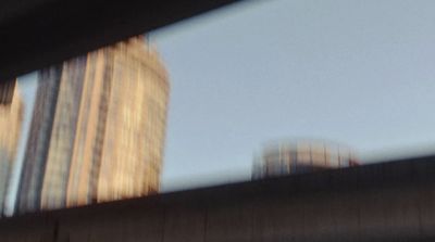 a blurry picture of a city with tall buildings