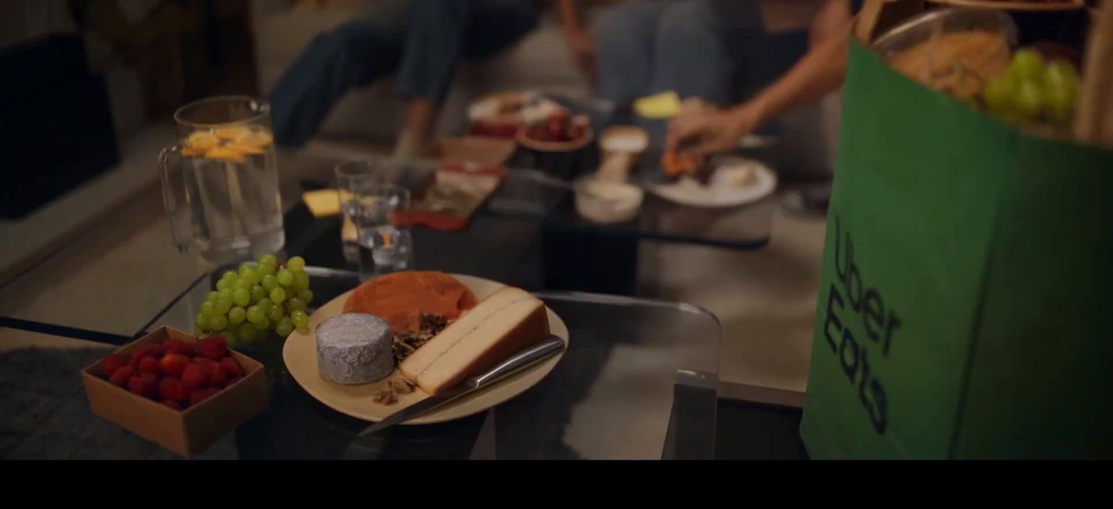 a group of people sitting around a table with food on it