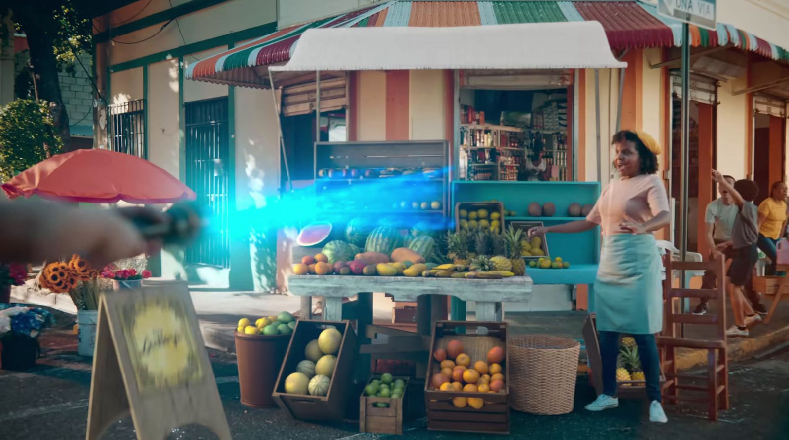 a woman standing in front of a fruit stand