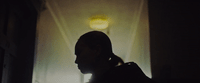 a silhouette of a person in a dark room