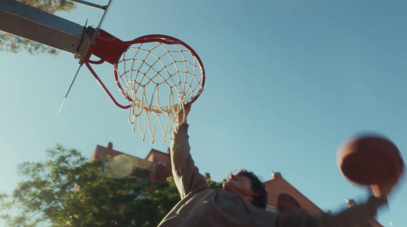 a man holding a basketball up in the air