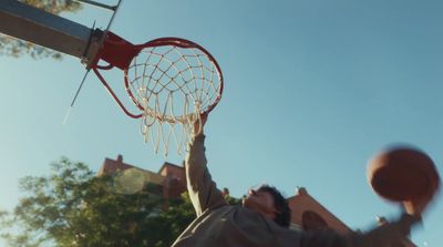 a man holding a basketball up in the air