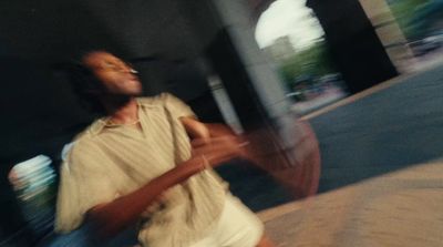 a man walking down a street holding an umbrella