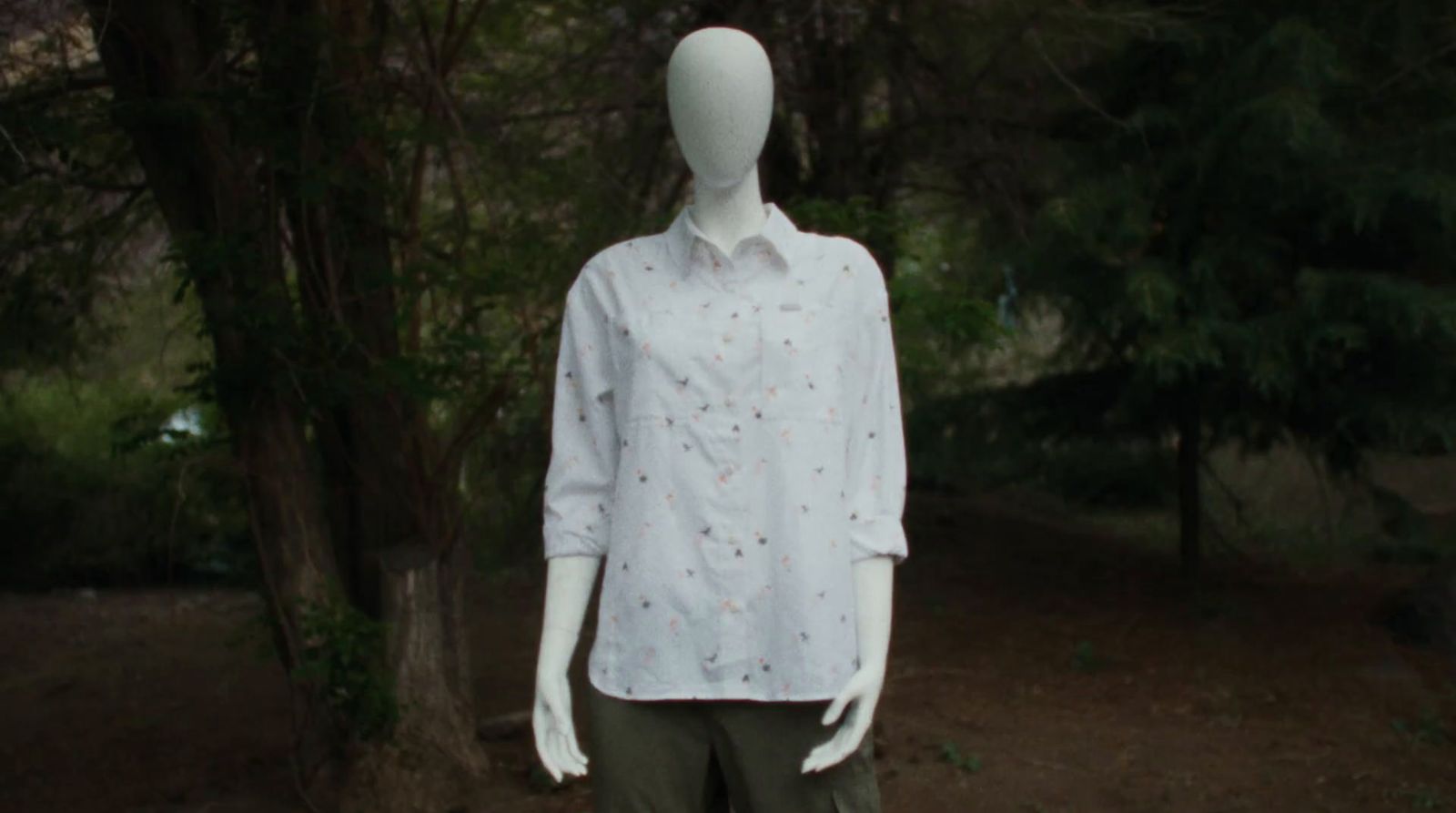 a mannequin wearing a white shirt and khaki pants