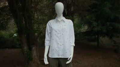 a mannequin wearing a white shirt and khaki pants