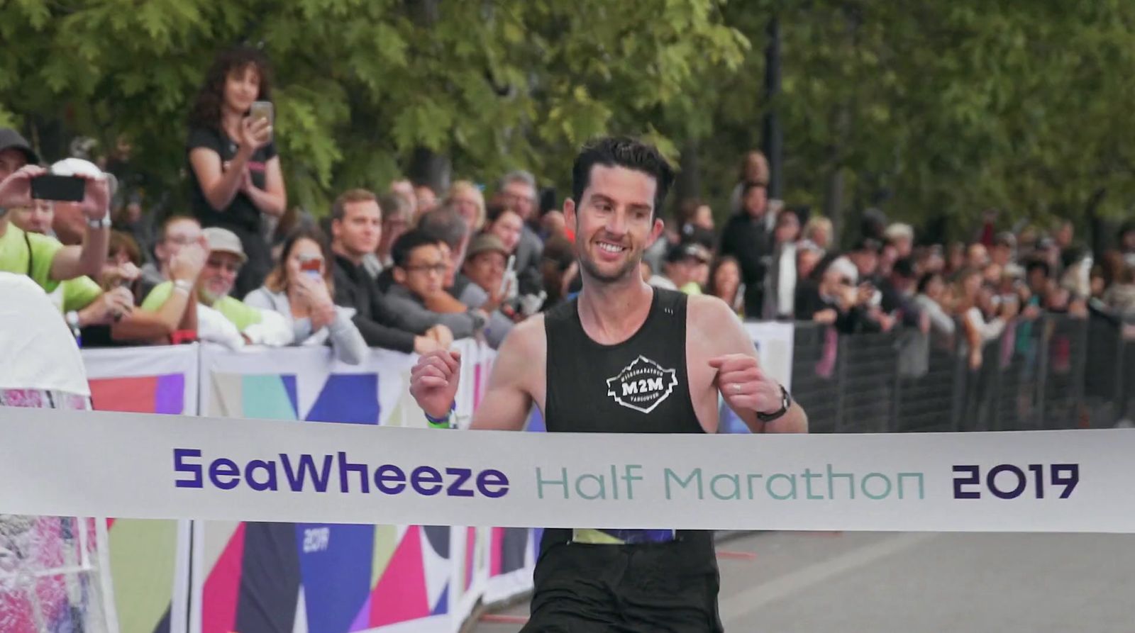 a man in a tank top running in a marathon