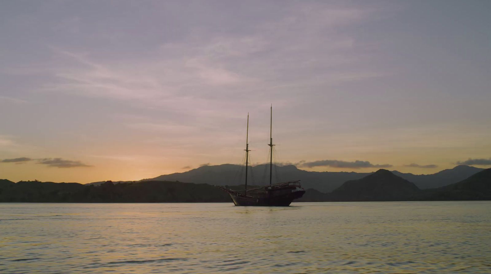 a boat floating on top of a large body of water