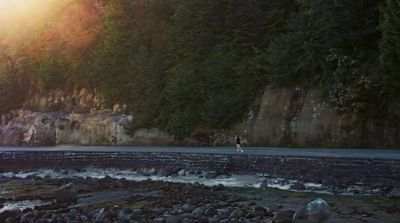 a person riding a surfboard on a rocky beach