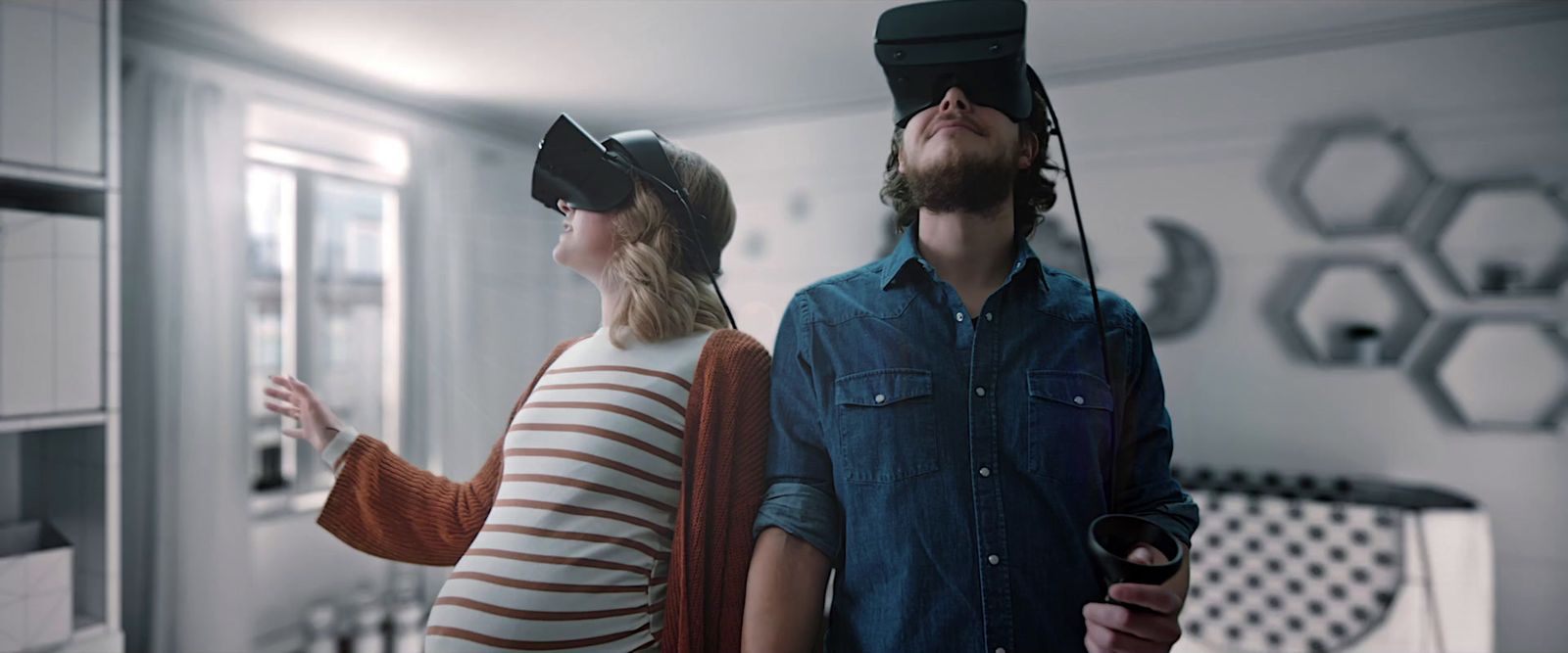 a man and a woman wearing virtual headsets in a kitchen