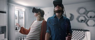 a man and a woman wearing virtual headsets in a kitchen