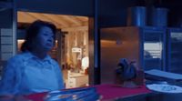 a woman standing in a kitchen next to a counter