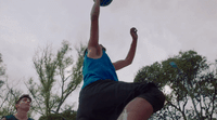 a person jumping in the air with a frisbee