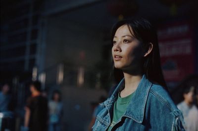 a woman standing in front of a crowd of people