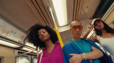 a man and two women standing on a train