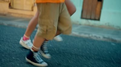 a person walking down a street with shoes on