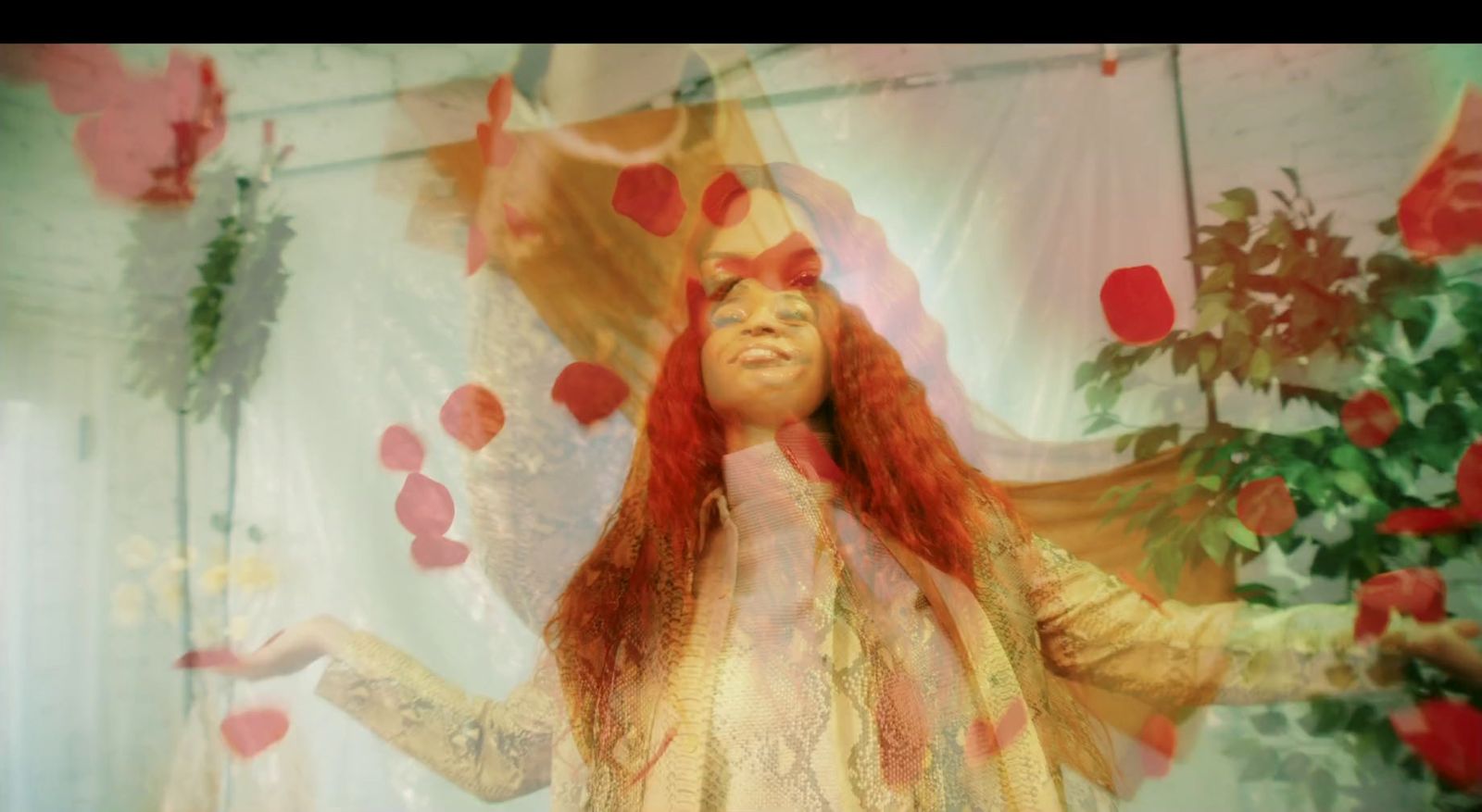 a woman with long red hair standing in front of a curtain