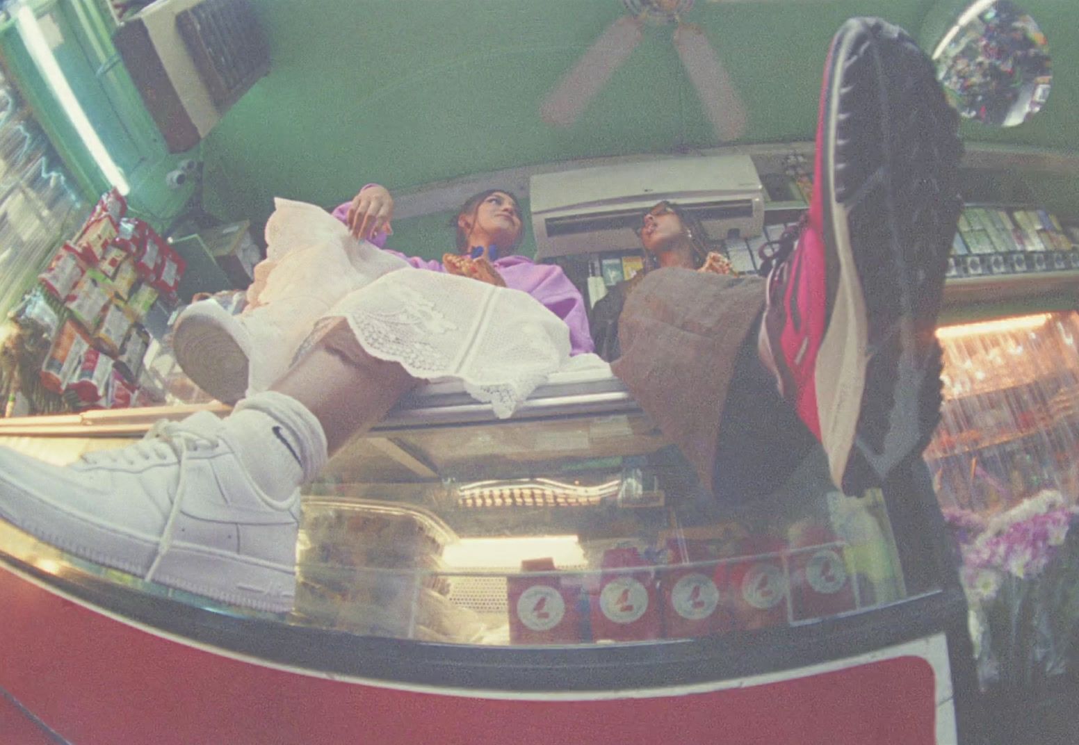 a couple of people sitting on top of a display case