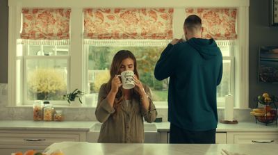 a man and a woman standing in a kitchen