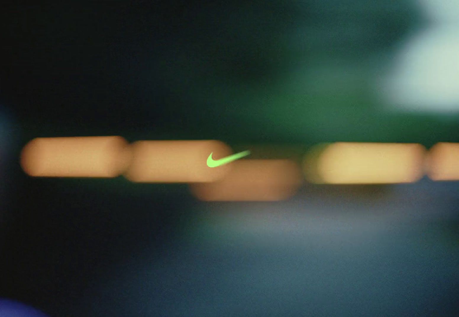 a blurry photo of a green nike logo