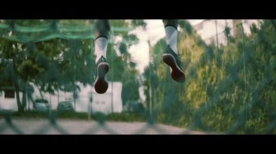 a person jumping in the air with their feet on a trampoline