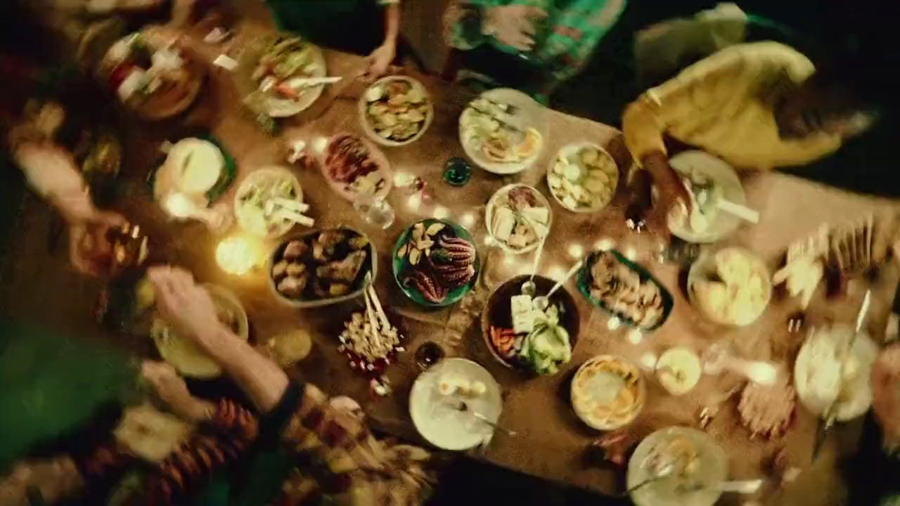 a group of people sitting around a table eating food