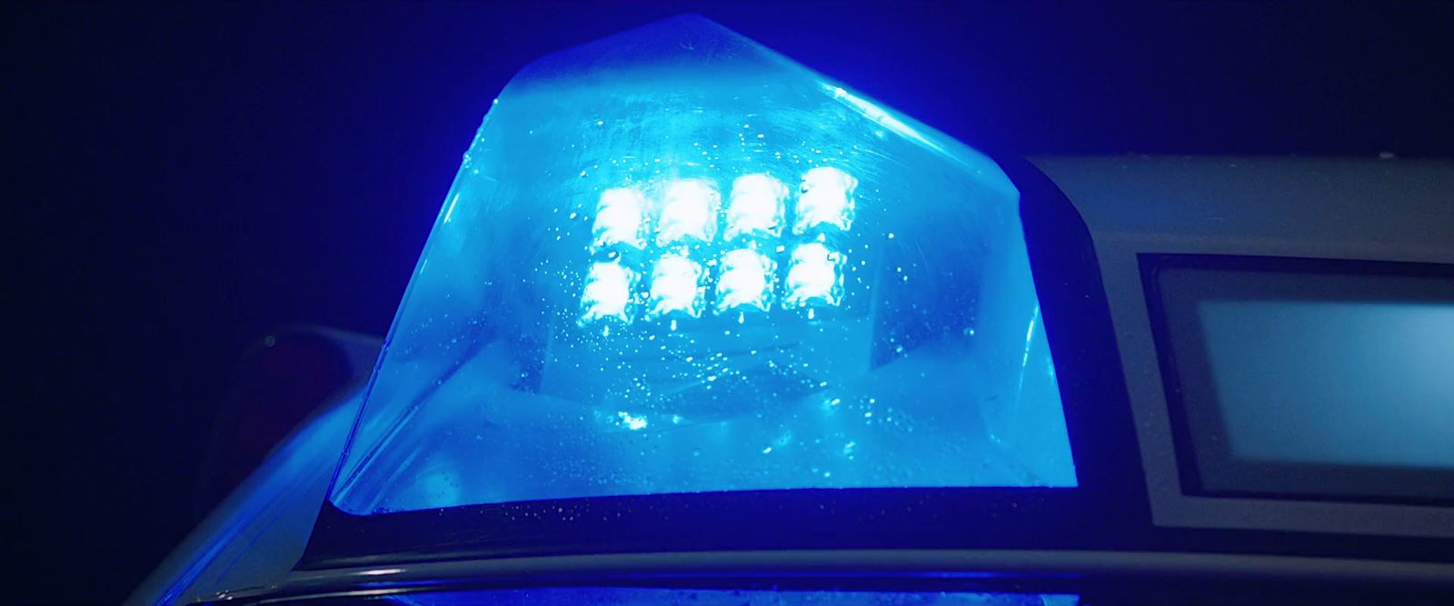 a close up of a traffic light with a blue light