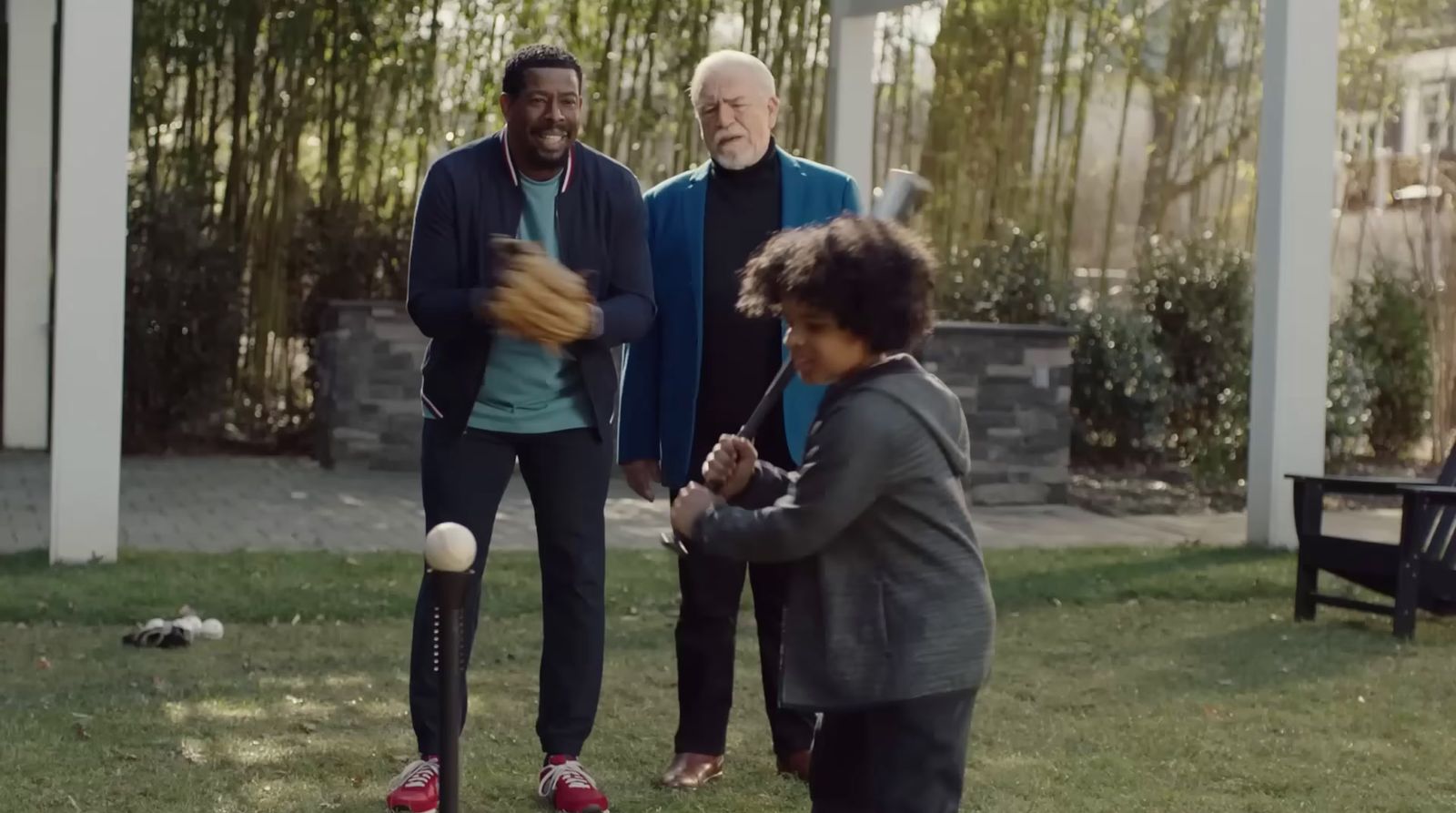 a group of people standing around a baseball field