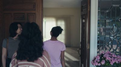 a couple of women standing in front of a door