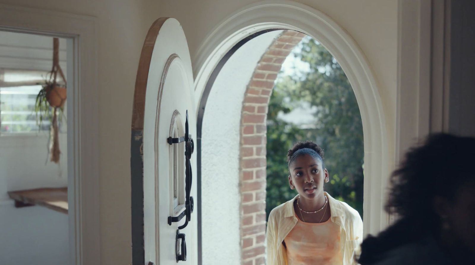 a woman standing in front of an open door