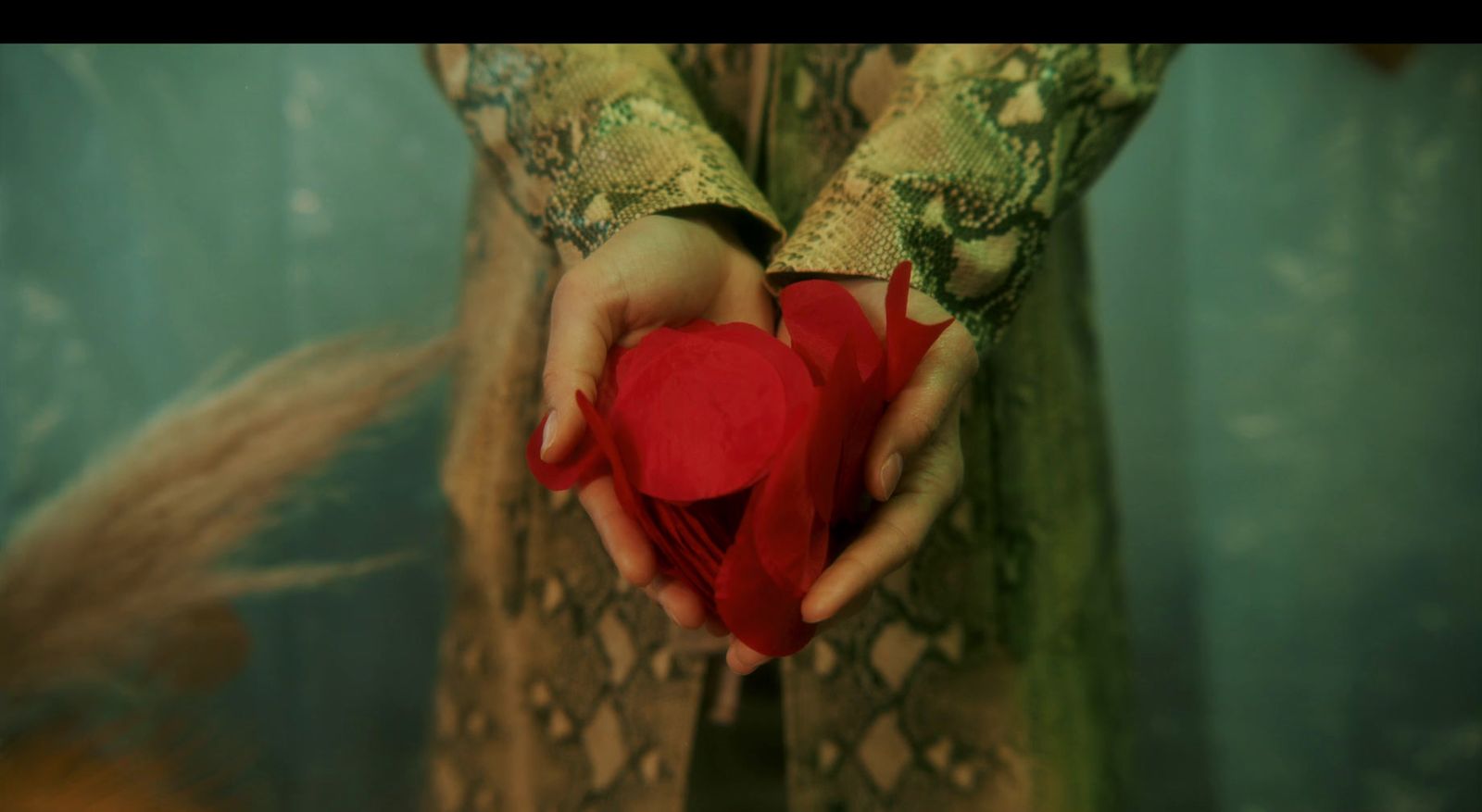 a woman holding a red heart in her hands