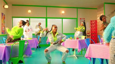 a group of people in a room with tables and chairs