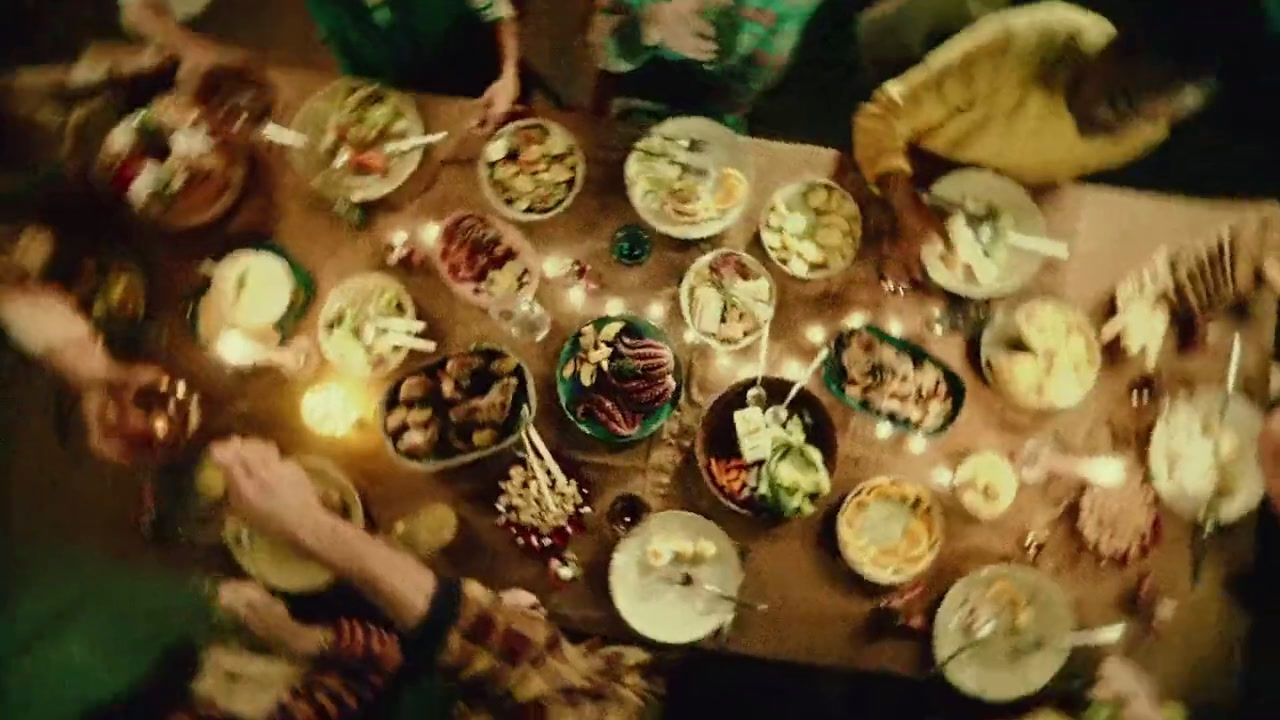 a group of people sitting around a table eating food